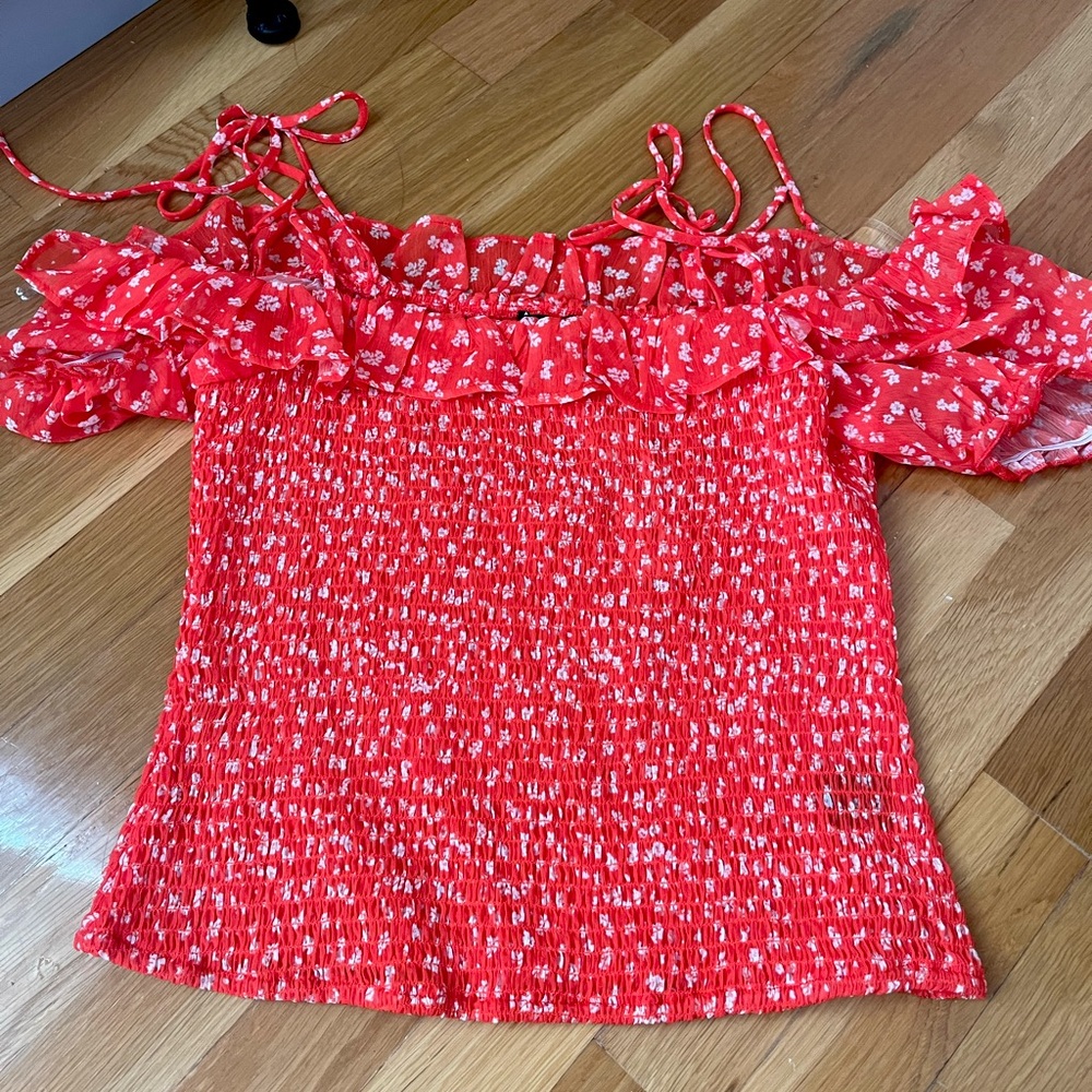 Francesca’s red blouse